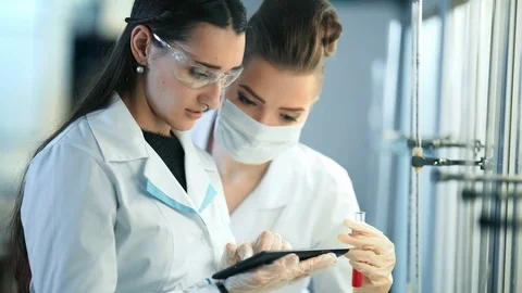 Young scientists with tablet pc making test or research in clinical laboratory Stock Footage
