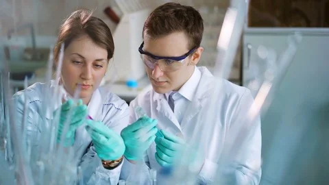 Young scientists working in modern biological lab Stock Footage 85327377