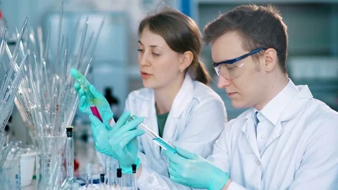 Young scientists working in modern biological lab Stock Footage 85327555
