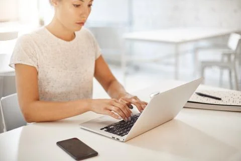 Young screenwriter using laptop computer to create her fist bestseller novel Stock Photos