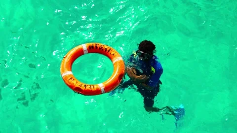 A young scuba diving instructor with a lifebuoy in the water. Stock Footage 324897157
