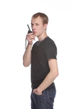 Young security officer talking through his walkie talkie. Stock Photos