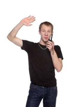 Young security officer talking through his walkie talkie. Stock Photos