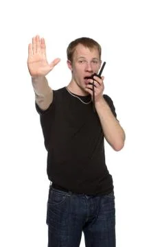 Young security officer talking through his walkie talkie. Stock Photos