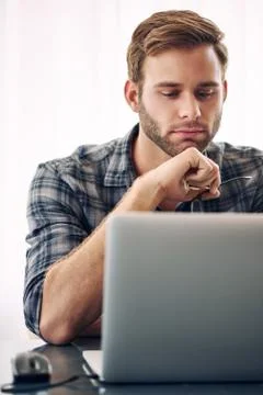 Young self employed writer working on his laptop Stock Photos
