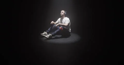 Young sensitive male dancer sitting on floor finishing contemporary dance Stock Footage 244525339