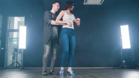 Young, sensual dance partners performing new moves Stock Footage 107426813