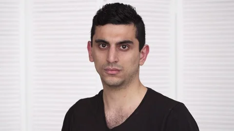 Young serious arabic man looking at camera Stock Footage 86382174