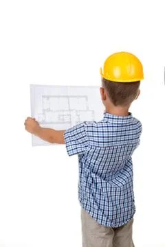 Young serious builder reading a construction plan, turned back, isolated on Stock Photos