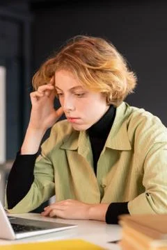 Young serious female developer of software looking through online information 写真素材