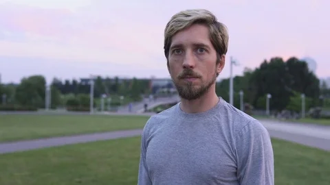 Young serious man looks at the camera Stock Footage 78733519