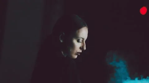Young sexy brunette over black background with smoke Stock Footage