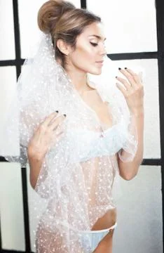 Young sexy romantic latin bride in erotic lingerie smiling Stock Photos