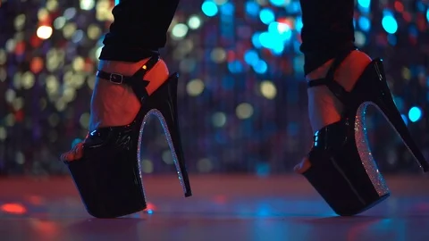 Young sexy stripper moving in high heels shoes with rhinestones on stage with Stock Footage