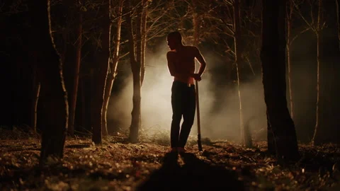 Young shirtless Man Digging a Grave with a Shovel in the forest Video stock 259110059