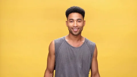 Young shocked african man over yellow background. Stock Footage