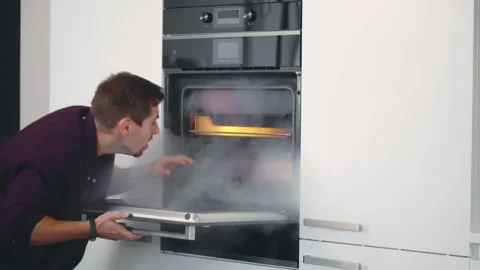 Young Shocked Man Opening Oven Filled With Smoke In Kitchen Stock Footage 140327280