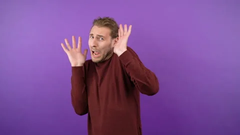 Young shocked scared guy in horror covers his eyes with his hands Stock Footage 149037258