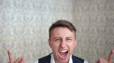 Young shouting and screaming guy feels happy, having fun posing and taking Stock Footage 58808349