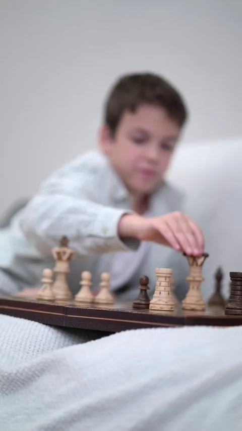 Young siblings bond over a classic chess game indoors Video stock 342771941
