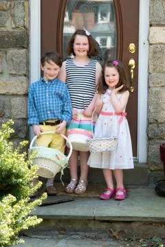 Young Siblings Outside Dressed Up for Easter holding Baskets Stock Photos