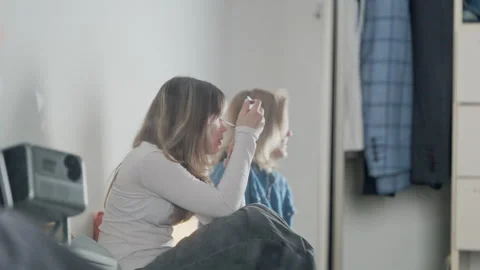 Young siblings playing and applying makeup together at home Stock Footage 332444509