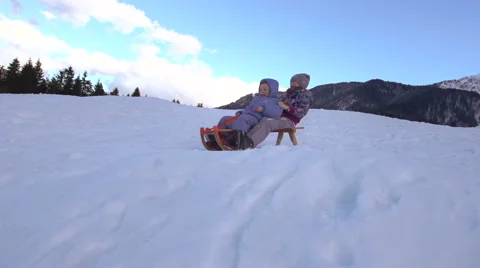 Young Siblings Toboggan Down The Snow Covered Hill On Sledge Stock Footage 45307548