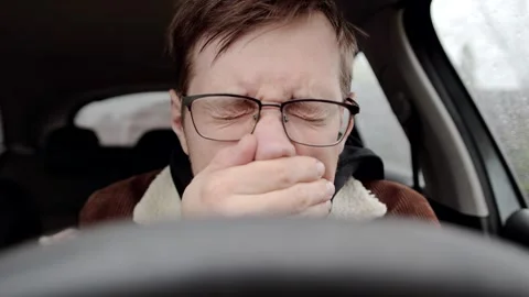 Young sick guy or allergic man sneezing inside a car. Stock Footage 320021333