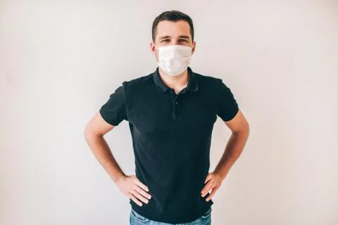 Young sick man isolated over background. Guy in black shirt wear medical Stock Photos