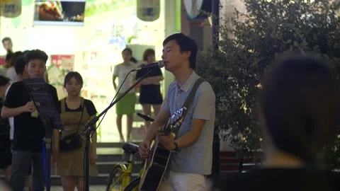 A young singer with a guitar Stock Footage 154986369