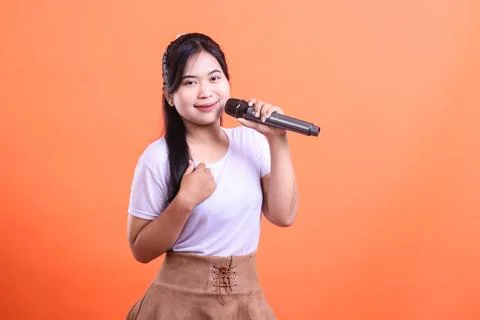 Young singer holding a microphone Stock Photos