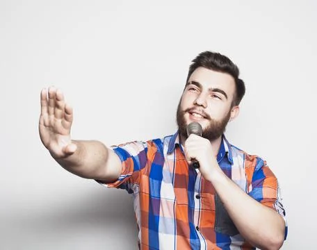 Young singer with microphone Stock Photos