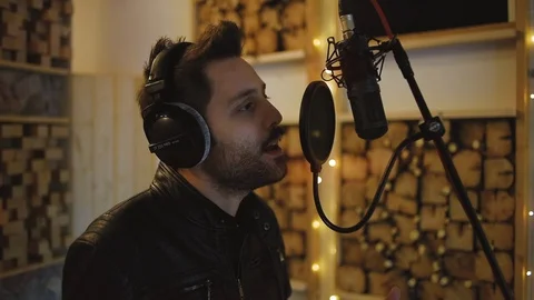 Young singer recording audio track in home recording studio Stock Footage 108013951