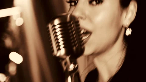 The young singer sings into the microphone. Video stock 44431884