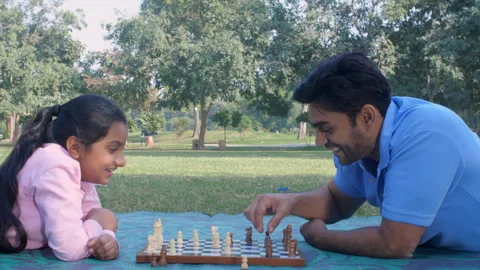 A young single father playing chess  with her daughter - responsible father Stock Footage 249529611