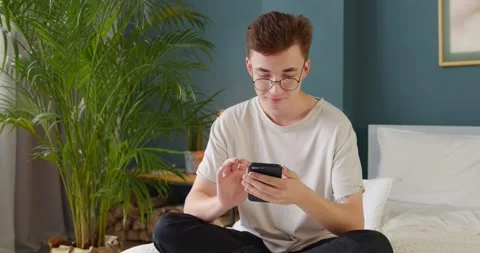 Young single man using dating app on his phone, swiping and touching Stock Footage 135531020