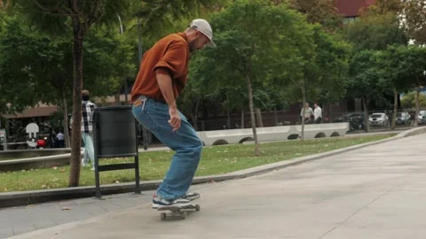 Young skater making 360 flip jump, performing kickflip trick, skateboarder Stock Footage 258376601