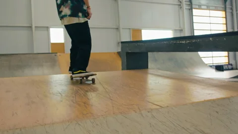 Young skater making jump, performing trick, skateboarder training in skatepark Stock Footage 240775623