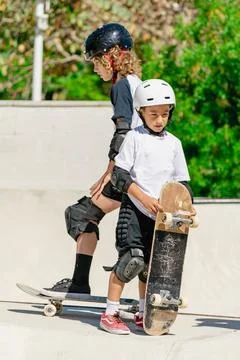 Young skaters learning new tricks at the skate park Stock Photos