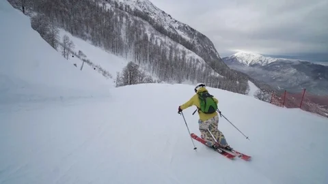 Young skier enjoys an empty track at a modern ski resort in the morning. Cloudy Video stock 101788099