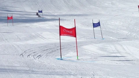 Young skier going down slope round flags Stock Footage 87186051