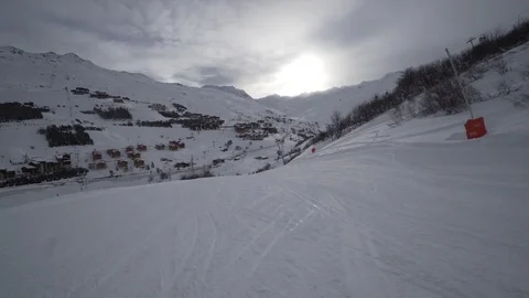 Young Skier man is Carving Down the Snowy Slope Wanderlust Stock Footage 84770424