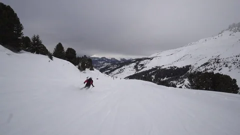 Young Skier man is Carving Down the Snowy Slope Wanderlust Stock Footage 84770681