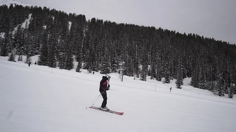 Young Skier man is Carving Down the Snowy Slope Wanderlust Stock Footage 84771365