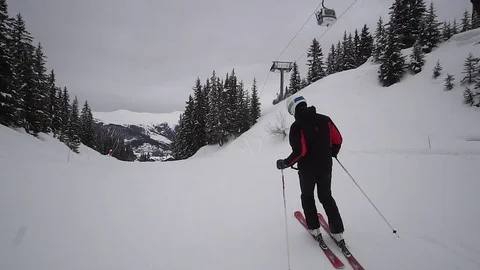 Young Skier man is Carving Down the Snowy Slope Wanderlust Stock Footage 84771645