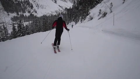 Young Skier man is Carving Down the Snowy Slope Wanderlust Stock Footage 84772029