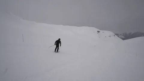 Young Skier man is Carving Down the Snowy Slope Wanderlust Stock Footage 84774312
