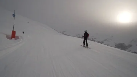 Young Skier man is Carving Down the Snowy Slope Wanderlust Stock Footage 84774545