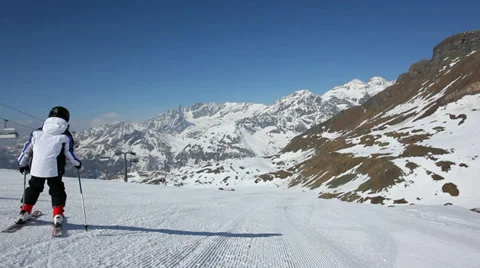 Young skier skiing down a slope in Cervinia, Val d'Aosta, West Alps, Italy, Stock Footage 34448937