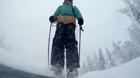 Young skier slides down the slope Stock Footage